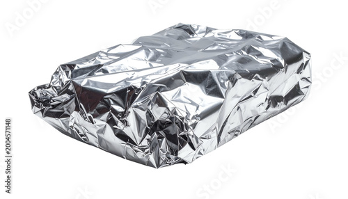 Metallic silver foil, crumpled around a rectangular object, isolated on a black backdrop