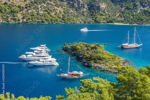 Luxury motor yacht sailing on the turquoise waters of the Mediterranean sea during summer