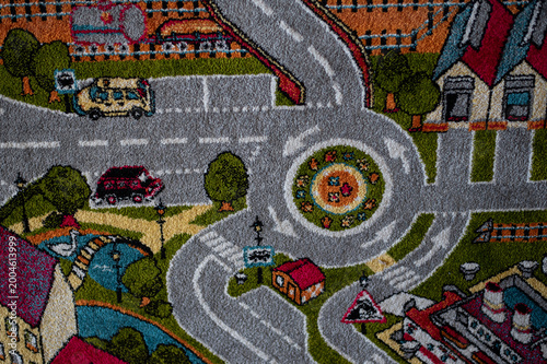 Obraz na plátne Close-up of a colorful tufted children’s rug featuring a playful city and road design