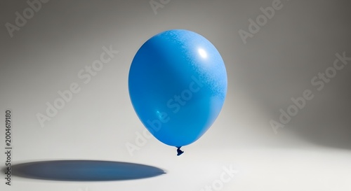 Blue balloon floating on minimal light background