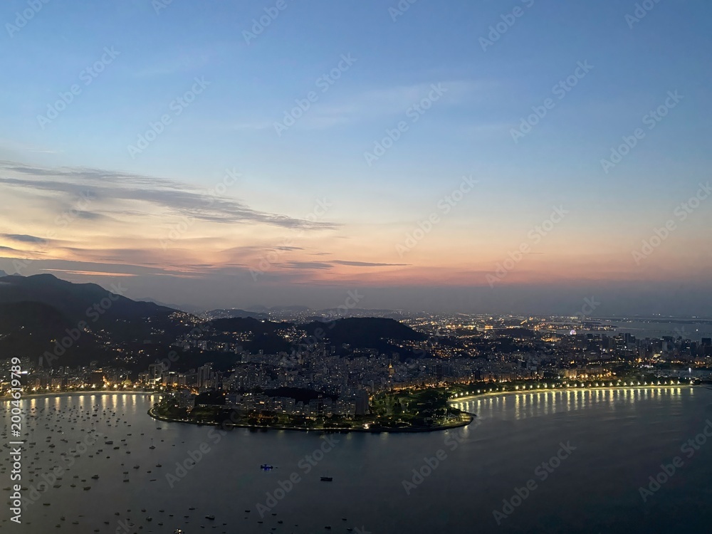 Fototapeta premium Sunset view of the coastline and city lights in Brazil capturing the beauty of the evening sky and city life
