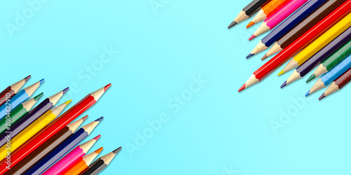 Horizontal wide banner Colorful pencils arranged in corners Clean copy space for text or design. Bright stationery Blue background perfect for school, education, creativity promotional layouts.