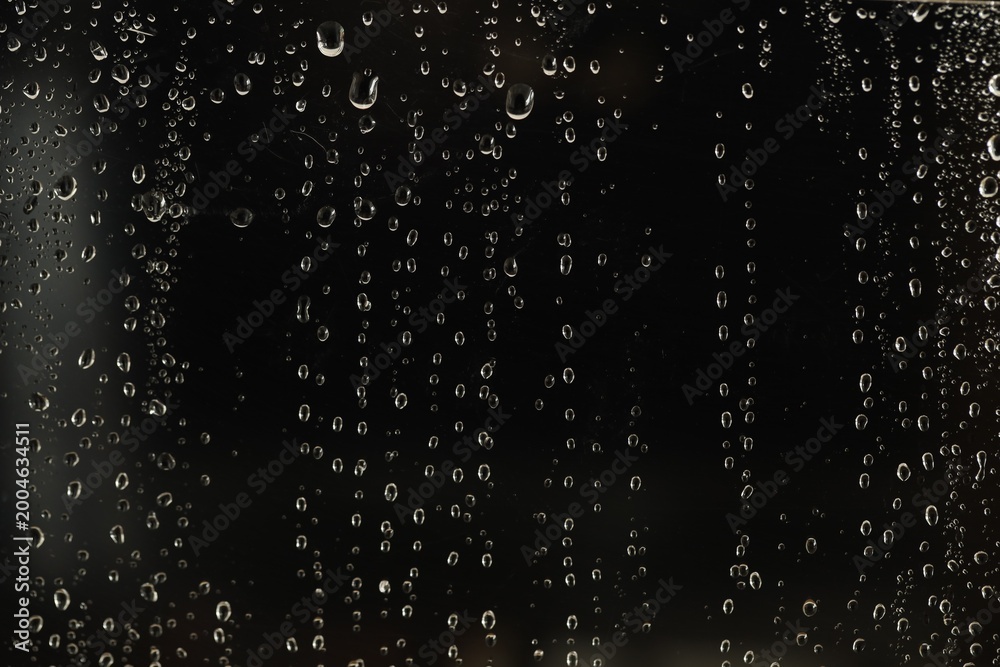Obraz premium Glass surface with water drops, closeup view