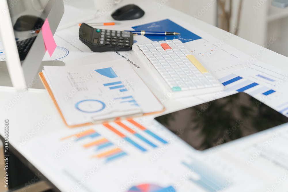 Fototapeta premium Businesswoman using calculator and laptop computer for analysis maketing plan, Accountant calculate financial report, computer with graph chart. Business, Finance and Accounting concept