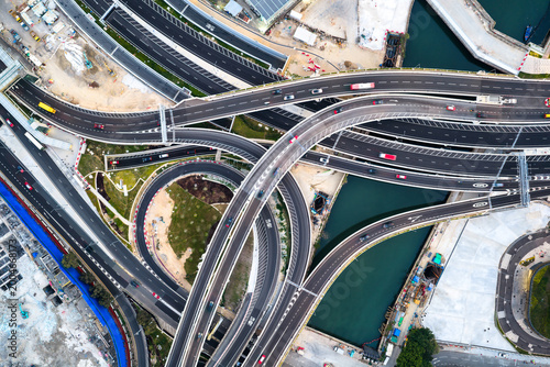 An aerial top down view of a complex multi level highway interchange in Hong Kong showcasing modern urban infrastructure and efficient traffic flow.