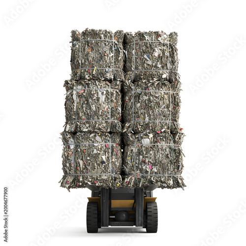 Trash bales stacked on forklift in industrial recycling facility  