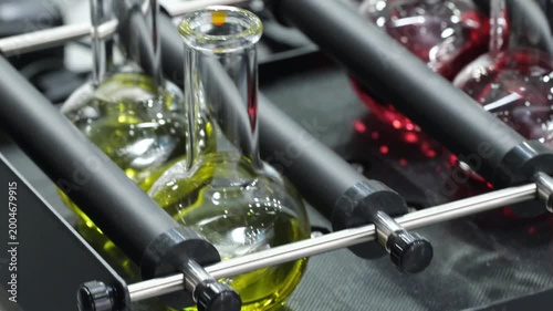Glass vials ampoules liquid mixed on device in medical laboratory, medical analysis concept