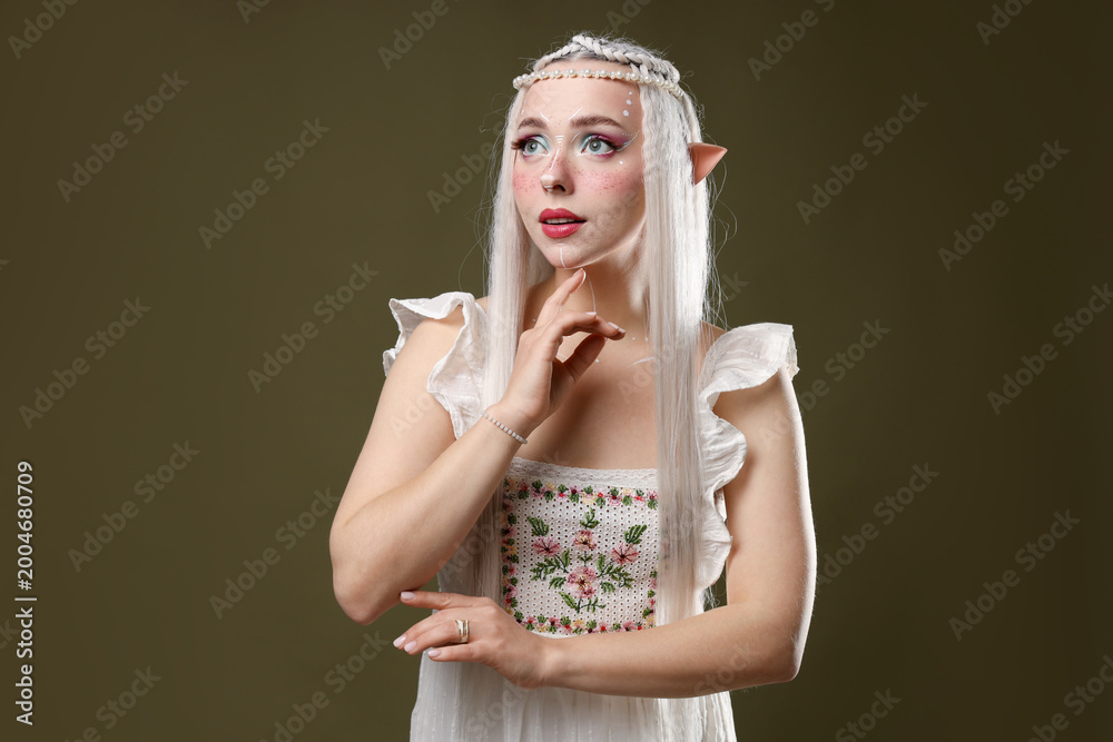 Fototapeta premium Beautiful elf girl on dark olive background