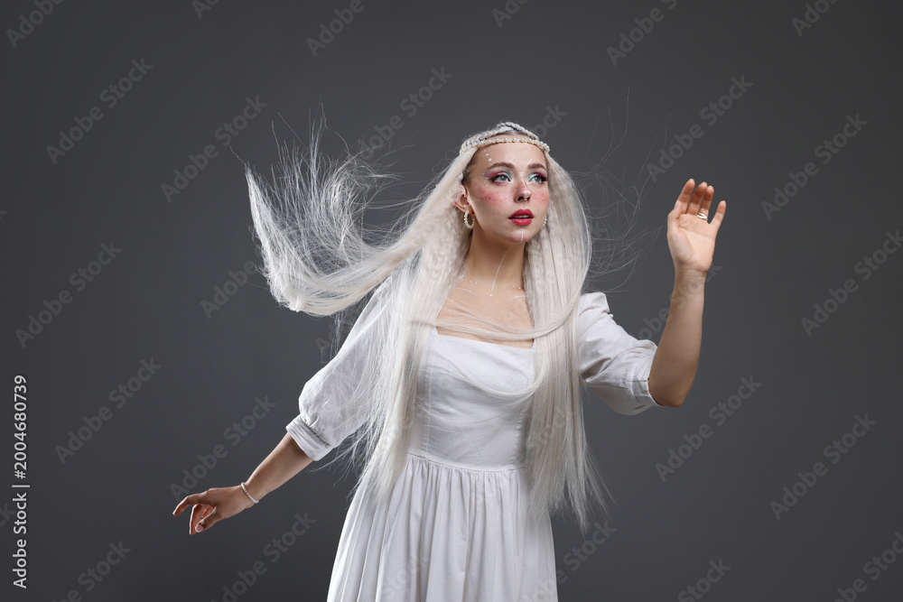 Fototapeta premium Beautiful girl dressed as elf on grey background
