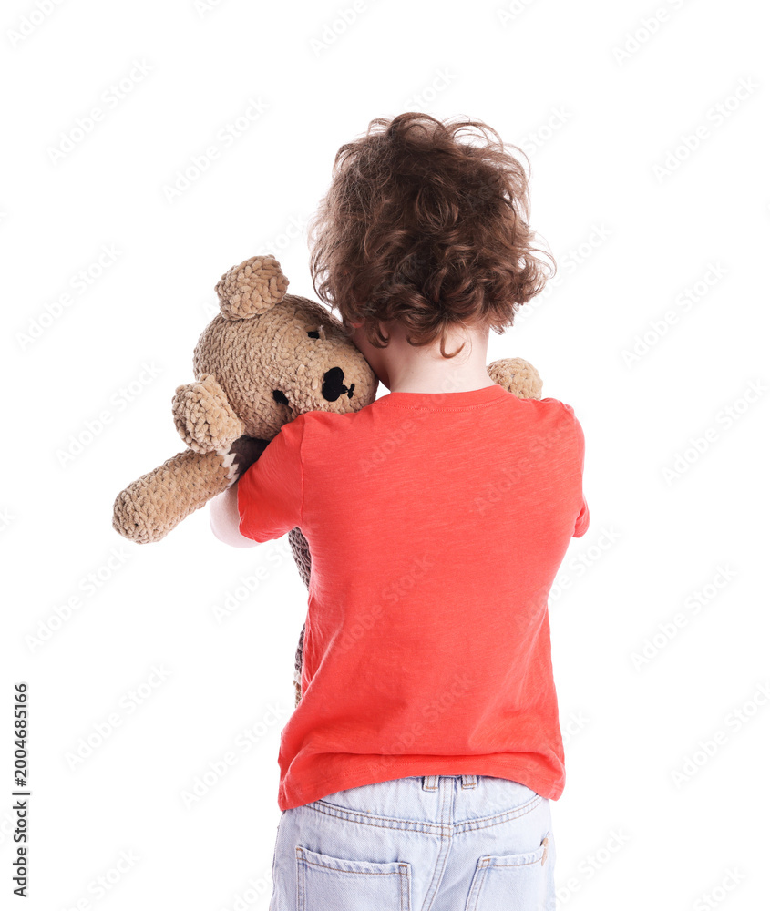 Obraz premium Little boy hugging plush toy bear on white background, back view