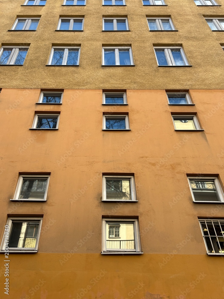 Fototapeta premium Two-Tone Apartment Building Facade with Symmetrical Windows