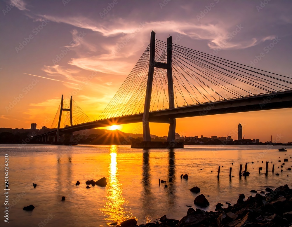 Obraz premium Modern cable bridge at sunset over water
