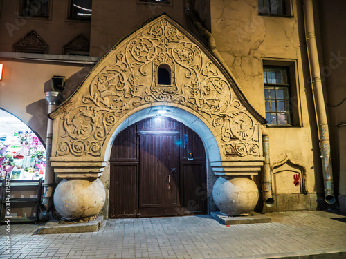 Ornate historical entrance facade with detailed stucco relief