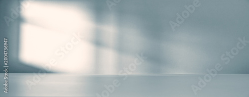 Obraz na plátně Banner of Minimalist empty room with soft natural light casting shadow on a wall