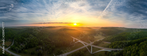 Aerial view of long bridge on a foggy morning sunrise