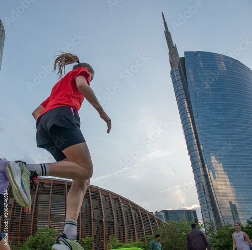 Girl doing gymnastics surrounded by skyscrapers