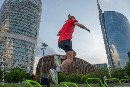 Girl doing gymnastics surrounded by skyscrapers