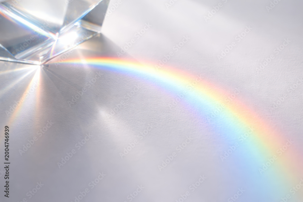 Fototapeta premium Prism creating a colorful rainbow on white surface