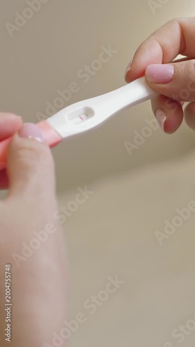 Woman holding in hands pregnancy test. Check quick pregnancy test kit. Vertical footage