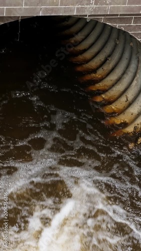 Water discharge. Ecology and environment pollution concept. Outdoors. Vertical footage