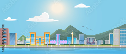View of a port city with mountains in the background.