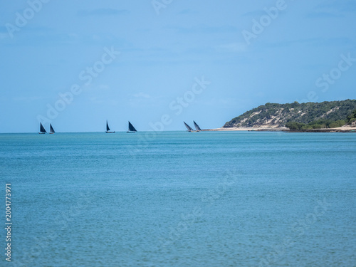 Sailboats on a Calm Turquoise Sea Along a Mediterranean Coast