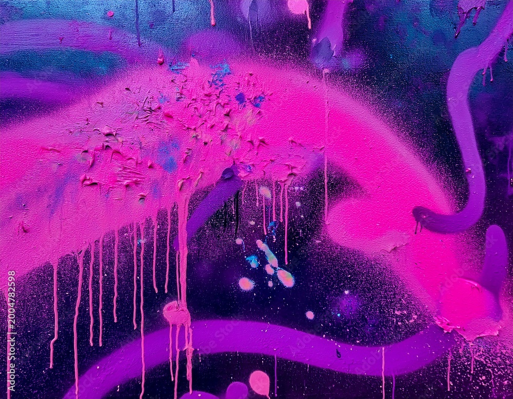 Naklejka premium close up graffiti on a wall features neon pink and purple spray paint paint splatter and abstract shapes representing urban street art