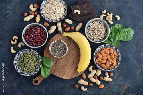 Top view of magnesium rich foods arranged on a dark background