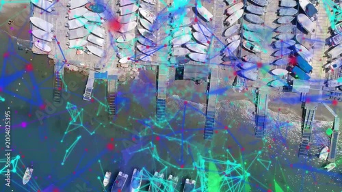 Camera descending, network overlay sweeping port while boats shifting and leaving, showing dock use