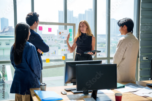 Business marketing strategy model ai team meeting presentation office data guide confident leader as colleagues review chart and graph by window with city view for growth plan