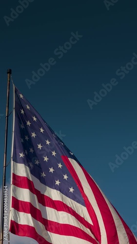 Vertical American Flag Waving In The Wind with Copy Space