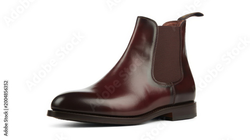 A single dark brown leather chelsea boot with a side elastic panel on a white background, shoe