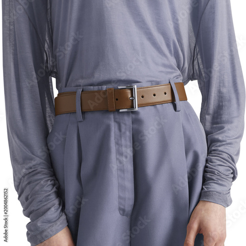 Close-up of a minimalist grey outfit featuring a soft, long-sleeve top tucked into high-waisted trousers, styled with a brown leather belt. Clean, modern fashion aesthetic with neutral tones,