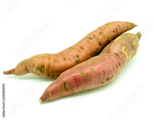 Two raw sweet potatoes with brown skin isolated on a plain white background, for cooking