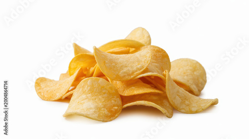 A pile of crispy golden potato chips stacked together isolated on a clean white background surface