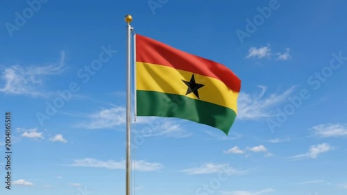 The Ghana flag flies against a bright blue sky.