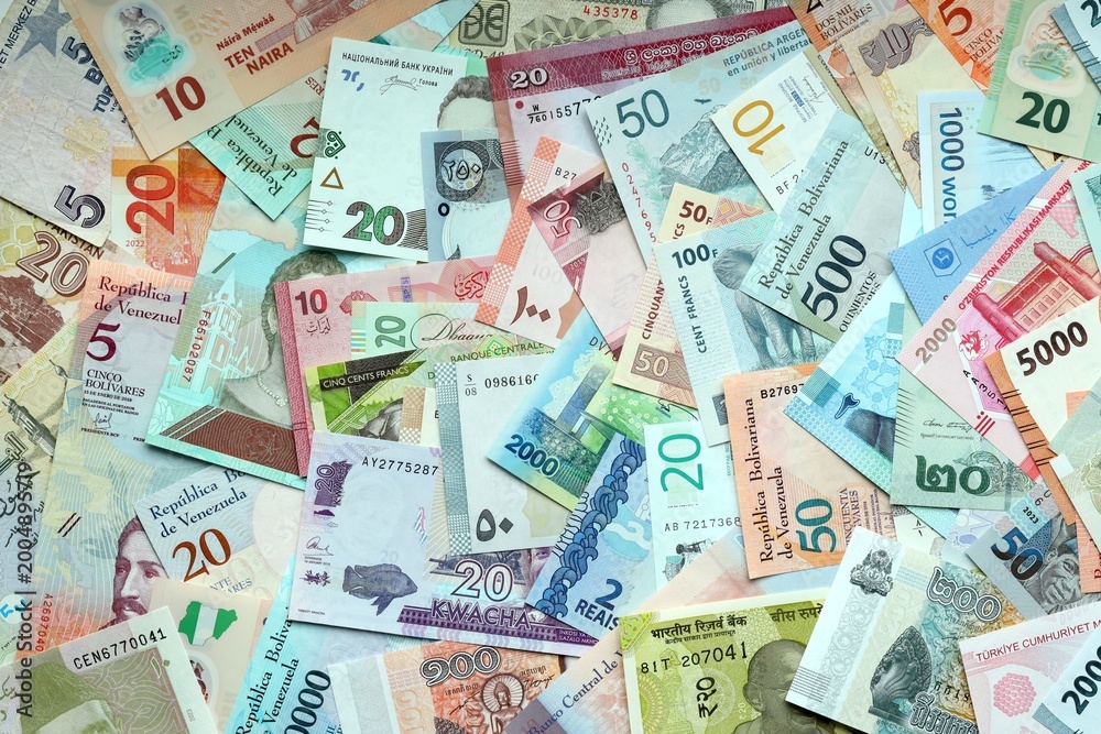 Fototapeta premium Big amount of money bills of various currencies. Assortment background of international cash