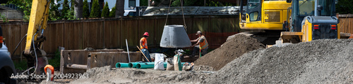 Photos Excavator boom arm being used to lower precast concrete stormwater system access