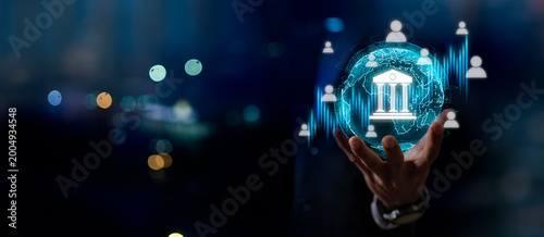 Photos Businessman holding digital bank icon with financial data interface, concept of