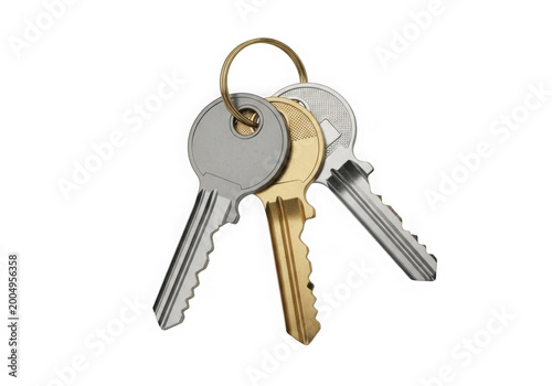 Three silver and gold keys on a keyring isolated on transparent background
