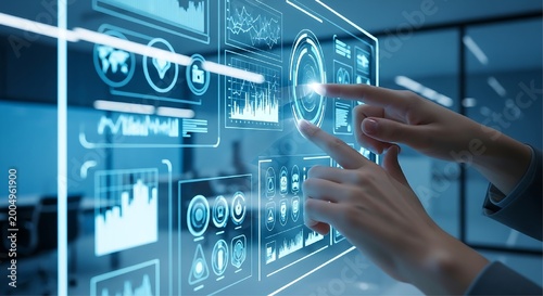 Two human hands touch a large glowing blue transparent digital screen displaying multiple data charts and world maps in a modern glass office environment.