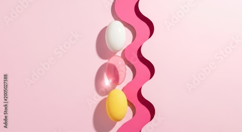 Three colorful oval objects next to a wavy pink shape