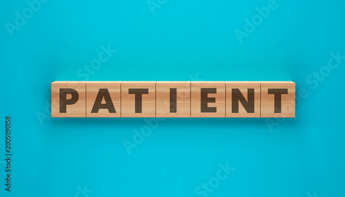 Fotografie Patient Word in Focus: A top-down view of the word patient spelled out with wood