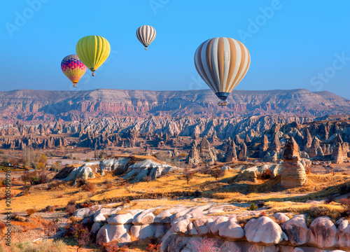 Hot air balloon flying over spectacular Cappadocia at sunset - Goreme, Turkey