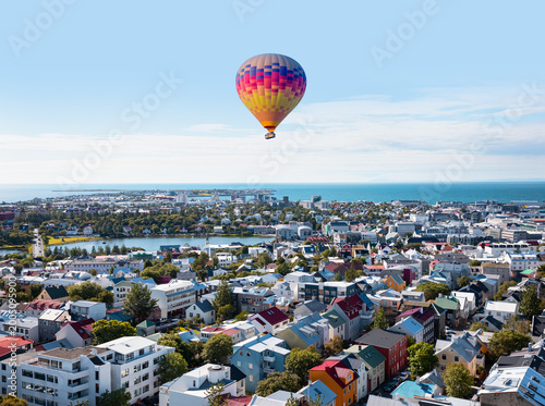 Hot air balloon flying over colorful buildings and Icelandic houses - Reykjavik, Iceland