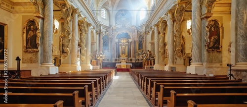 Grand interior view of an ornate historic church nave with rows of wooden pews leading towards a richly decorated altar and apse