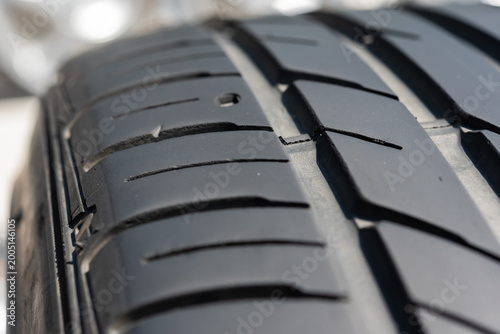 Bild auf Leinwand Closeup of car tire tread pattern showing deep grooves and rubber texture for tr