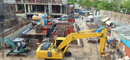 Construction site shows heavy equipment such as excavators .