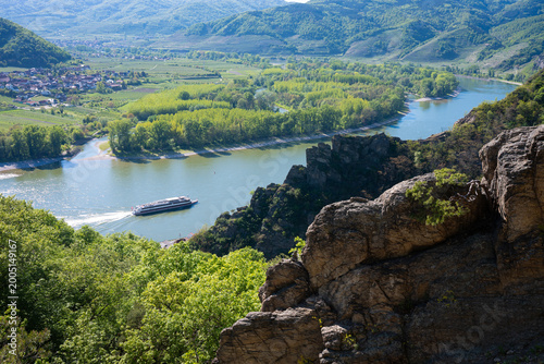 Scenic high angle view of a river cruise ship sailing on the Danube river through the beautiful Wachau Valley, Austria