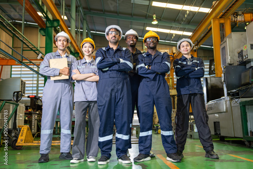 Team of engineers collaborating on industrial solutions in manufacturing plant environment professional teamwork and innovation